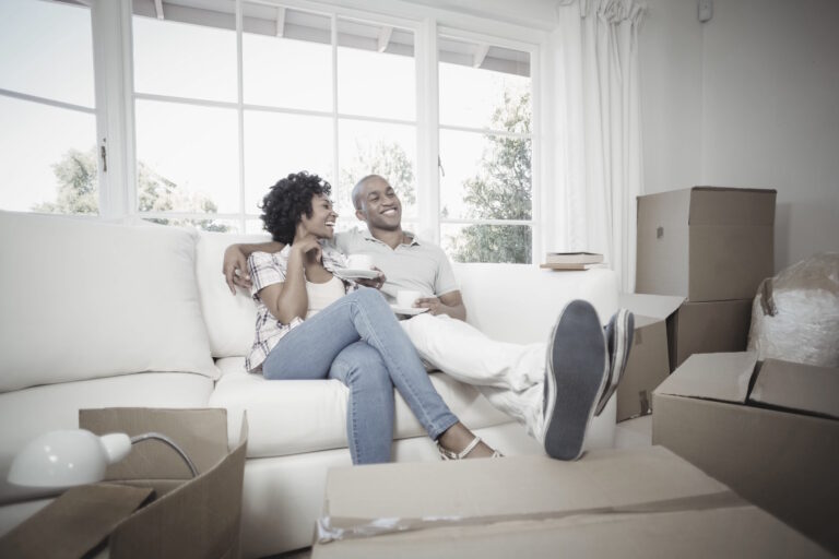 buyers relaxing on sofa in new home